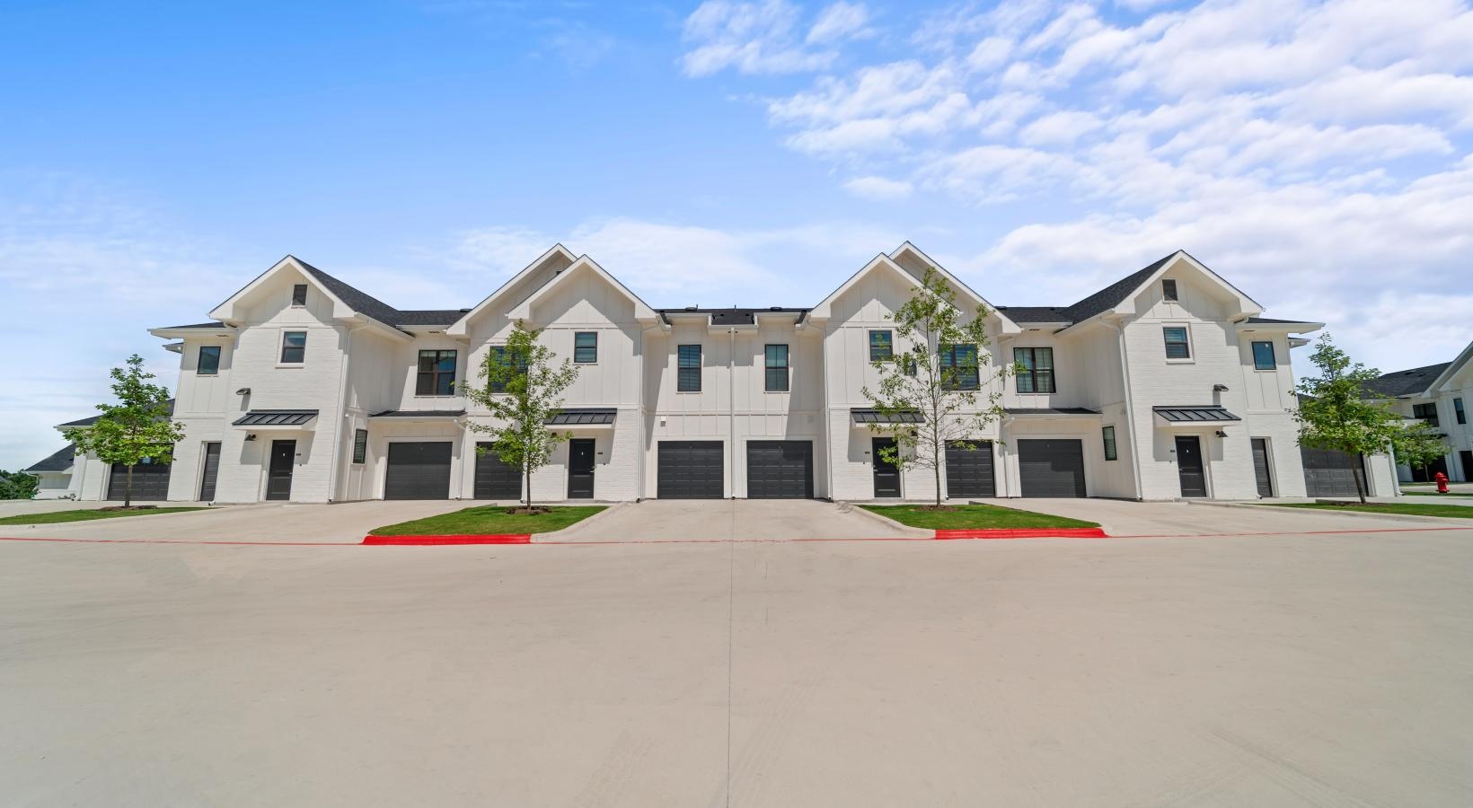 The essence of exceptional living a large white building with trees and grass in front of it