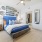 a bedroom with a bed and a mirror