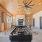 a room with a pool table and a large fan