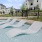 a pool with a deck and chairs