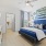 a bedroom with a bed and a fan