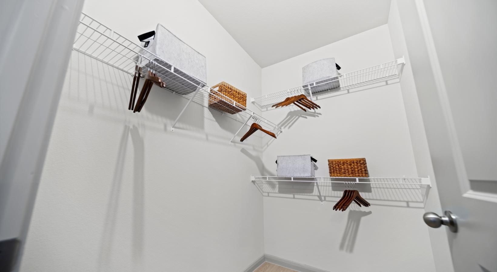 All the comforts of luxury living a white room with a white wall and shelves with objects on them