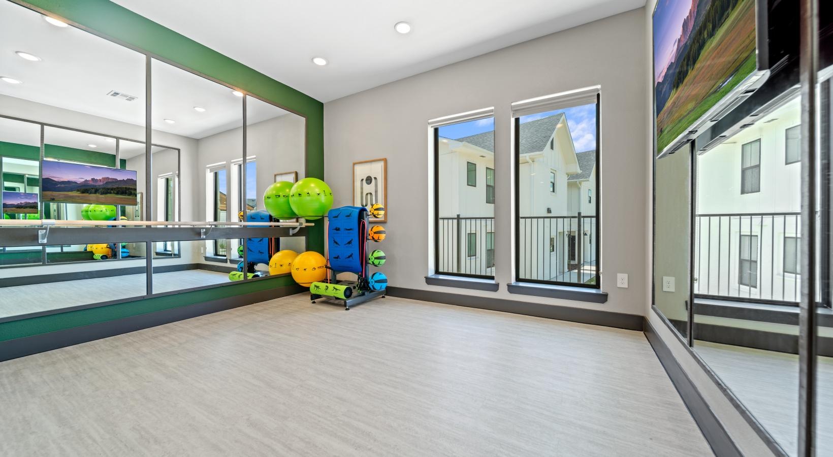 State-of-the-art amenities a room with a glass wall and a glass floor with a large glass window and a large green