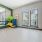 a room with a glass wall and a glass floor with a large glass window and a large green