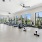 a room with exercise equipment and windows